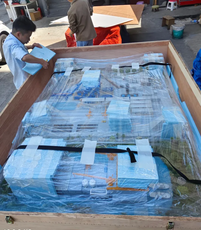industrial model packing shipping Worker packing large industrial port scale model in wooden shipping crate