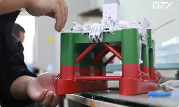 offshore rig model assembly Hand-assembled offshore drilling rig model in workshop