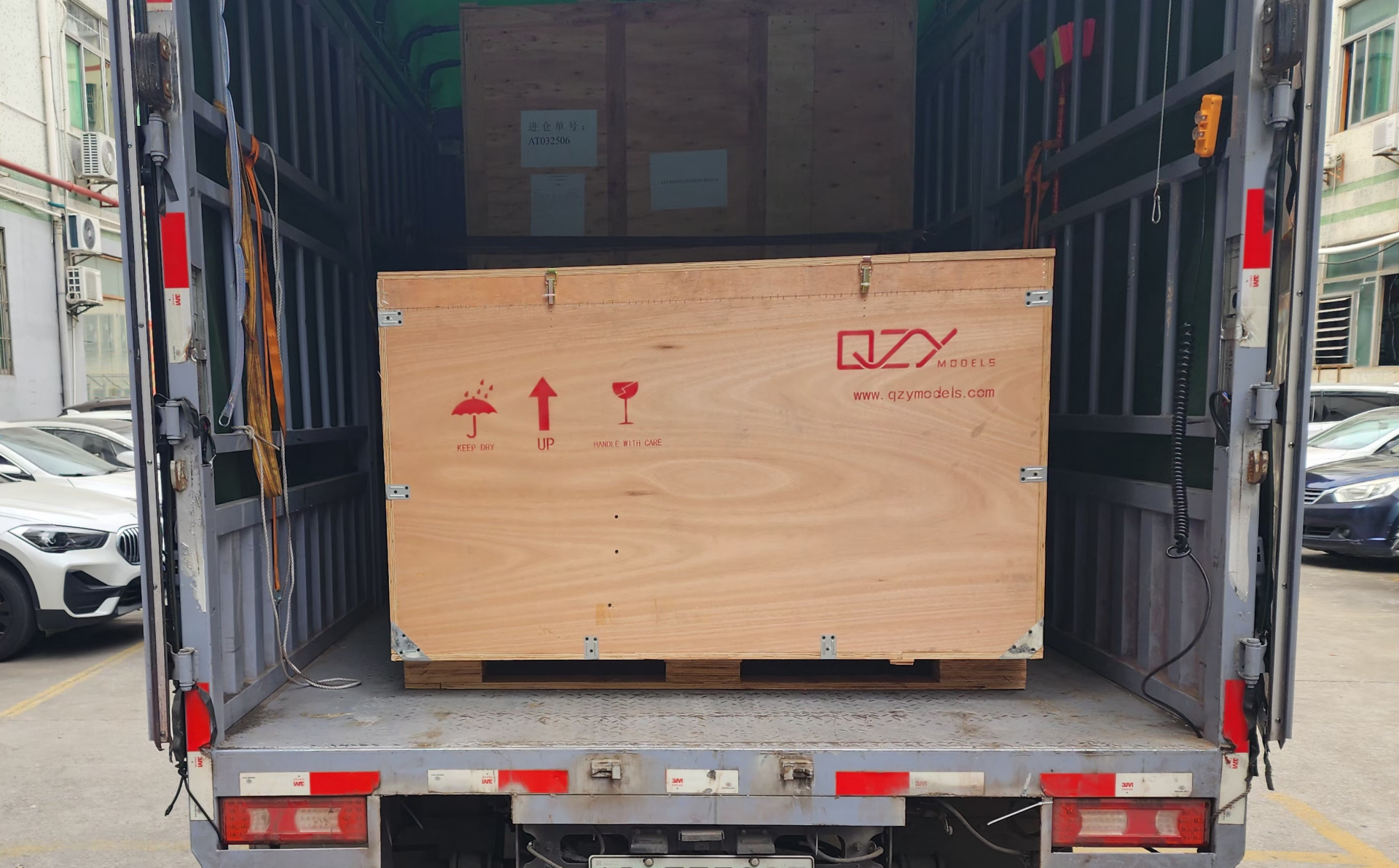 Crated Architectural Model Secured for Port Shipment Sealed and crated architectural model carefully packed and loaded onto a truck, ready for transport to the port for international shipping