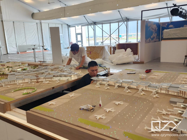 On-Site Assembly of Modular Architectural Model Team assembling modular architectural model components on-site during installation and presentation setup