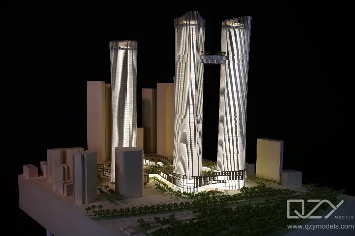 A high-rise scale model displayed alongside surrounding existing buildings, demonstrating the tower's relationship to its urban context.