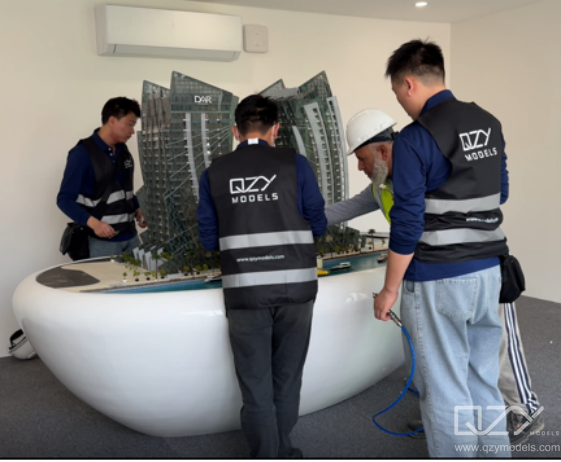 QZY Models maintenance and installation team preparing architectural model. QZY Models technicians servicing and preparing an architectural model before an international exhibition.