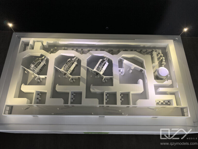 A medical equipment scale model displayed on a manufacturer's exhibition stand at an international healthcare trade even.